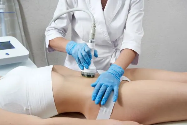 Lost the Weight but Not the Loose Skin? 2 woman having HIFU treatment on her stomach to combat loose skin Sutton following weight loss